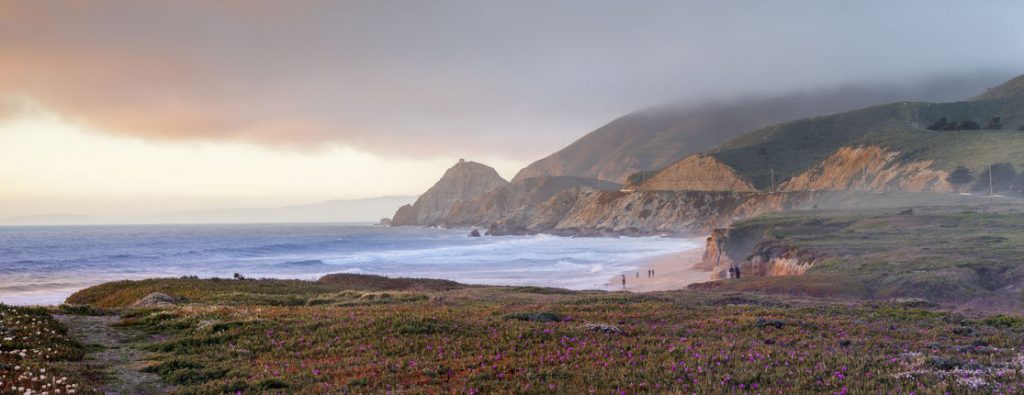 Coastline photo showing mountain bluffs and the beach
