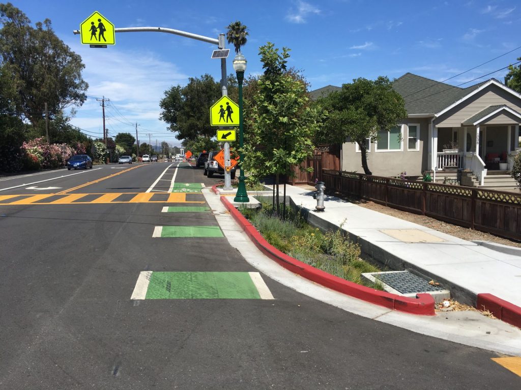 Curb Extensions with stormwater capture from landscape aesthetics; street light and crosswalk